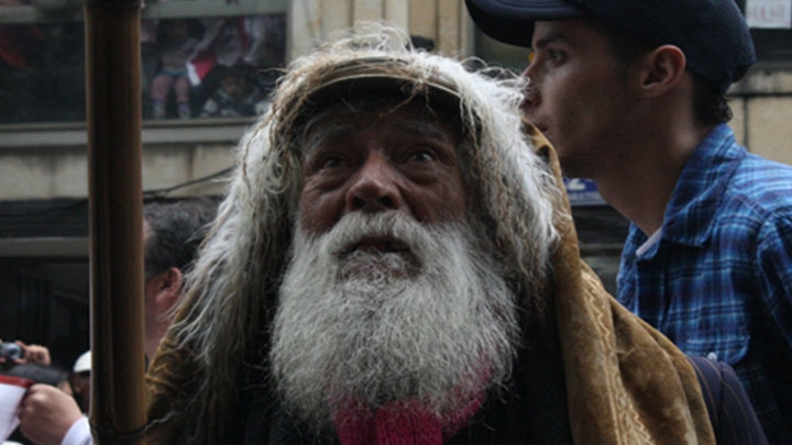 Un cham&aacute;n realiza sus rituales para suspender la lluvia antes del inicio de la marcha.