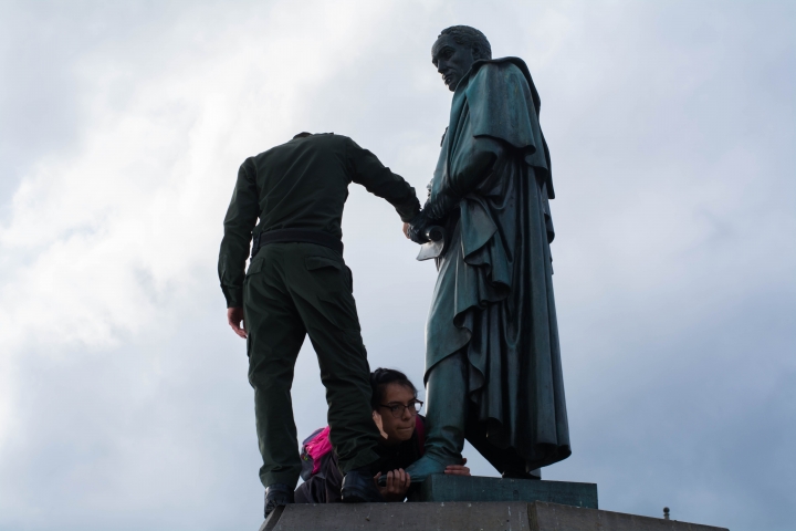 Aferrada al pie de la estatua desvestida, la mujer que intent&oacute; convertir a Sim&oacute;n en "Simona" hace resistencia. Foto: Juli&aacute;n R&iacute;os